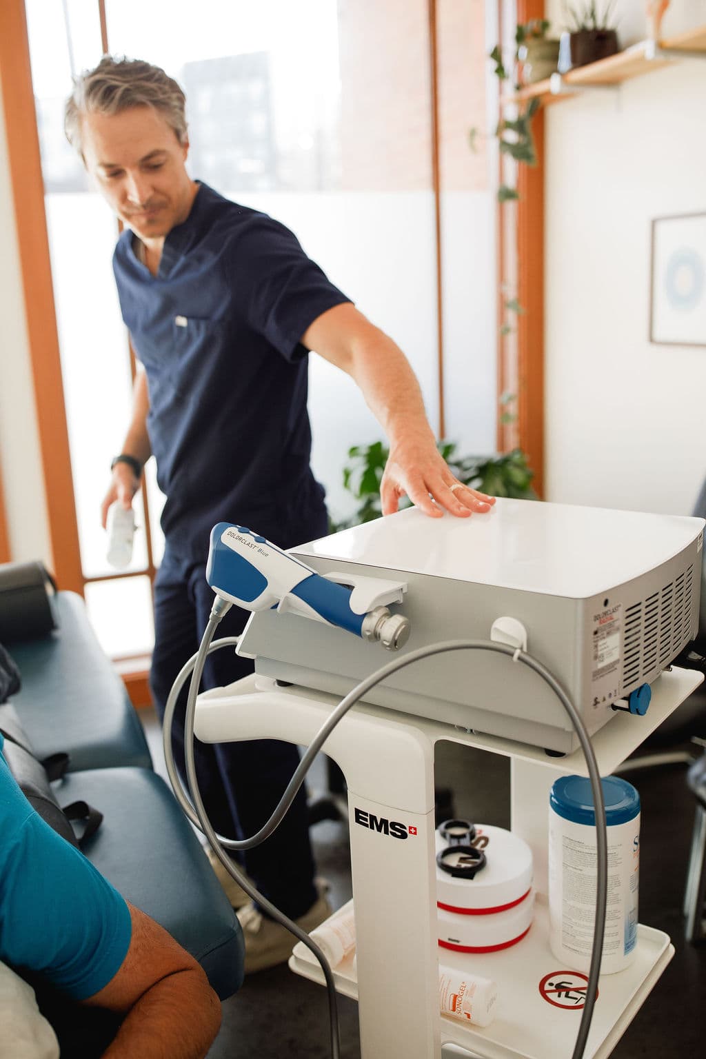 Dr. Borys preparing the shockwave therapy device in his Bellingham clinic