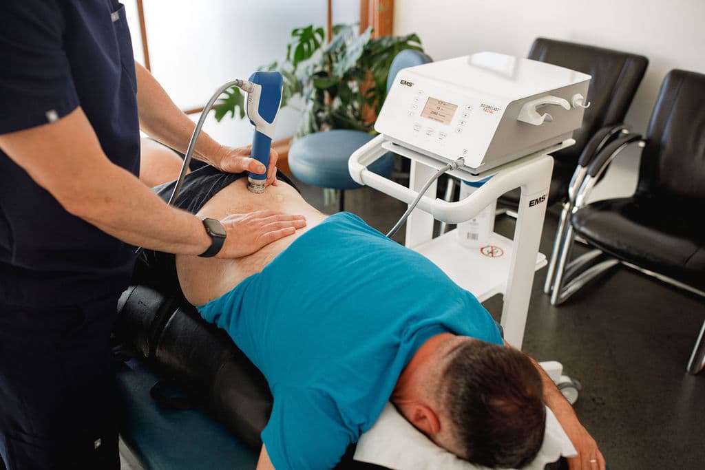Dr. Borys performing shockwave therapy