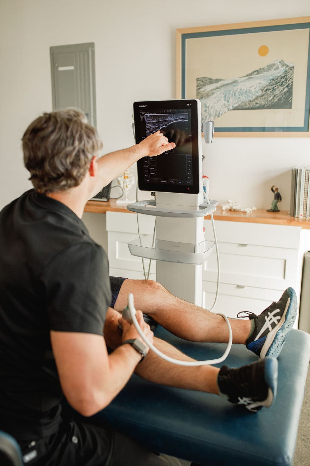 Dr. Borys reviewing an ultrasound scan during a treatment session